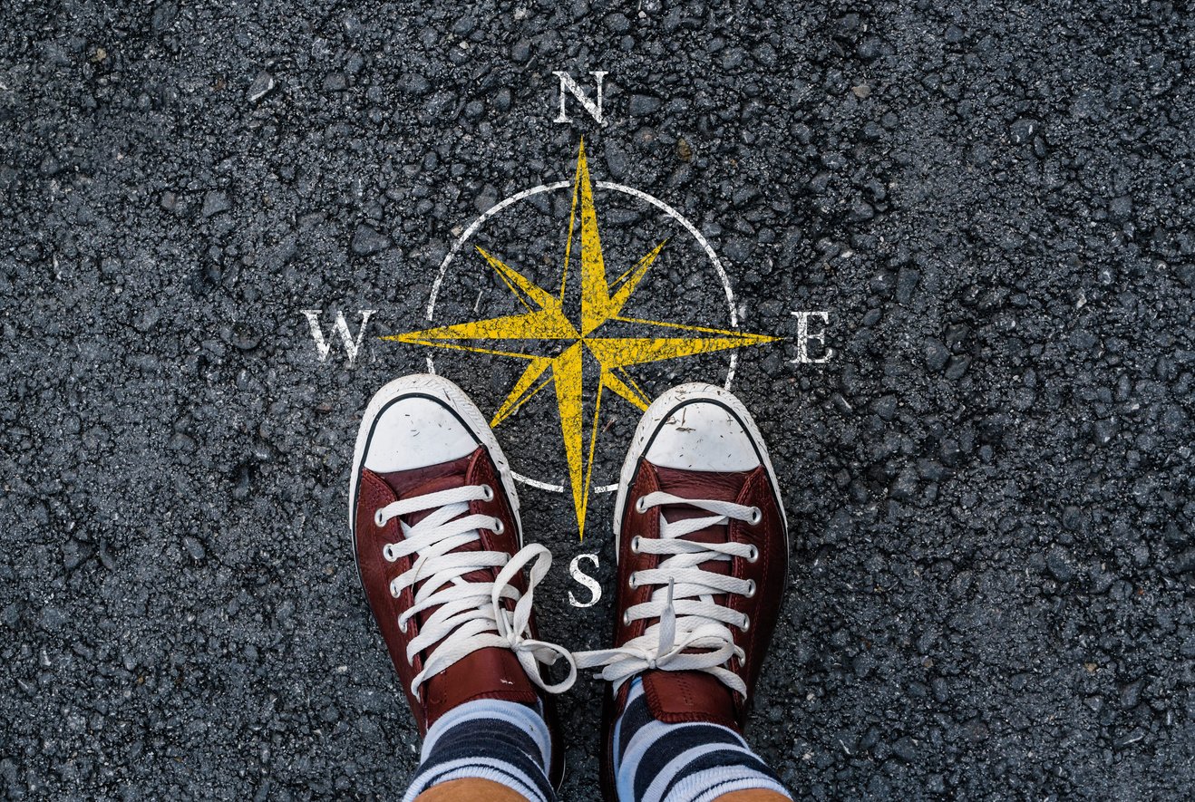 compass sign on road asphalt